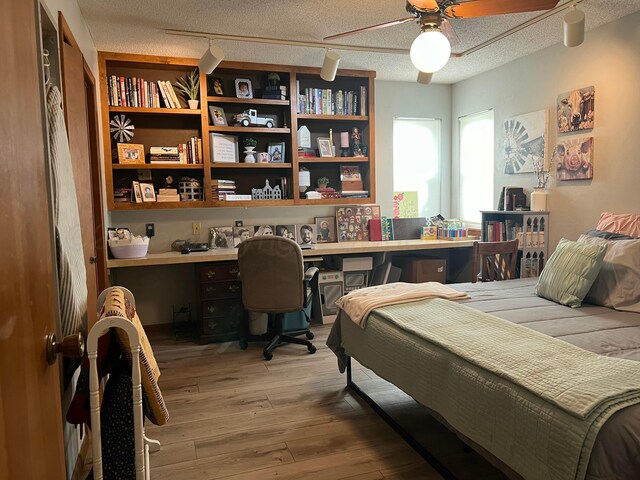 14680 County Road 6, Booker, TX 79005 - bedroom featuring wood-type flooring and a textured ceiling