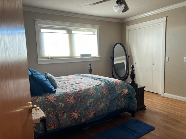 14680 County Road 6, Booker, TX 79005 - bedroom featuring wood finished floors, baseboards, ceiling fan, a closet, and crown molding