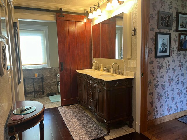 14680 County Road 6, Booker, TX 79005 - bathroom featuring wood finished floors, double vanity, crown molding, and wallpapered walls
