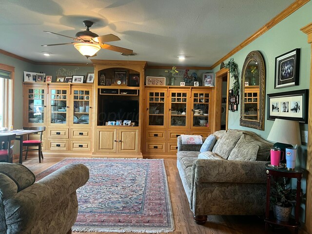 14680 County Road 6, Booker, TX 79005 - living area with wood finished floors, a ceiling fan, and crown molding