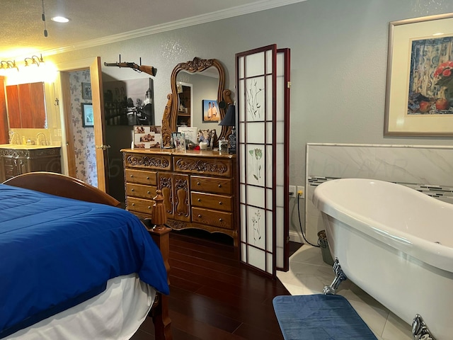 14680 County Road 6, Booker, TX 79005 - bedroom with crown molding, wood finished floors, and connected bathroom