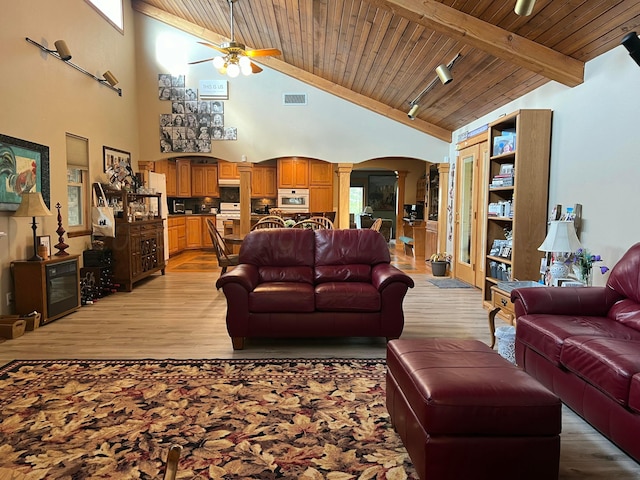 14680 County Road 6, Booker, TX 79005 - living area featuring wood ceiling with exposed beams, ornate columns, arched walkways, a ceiling fan, and high vaulted ceiling