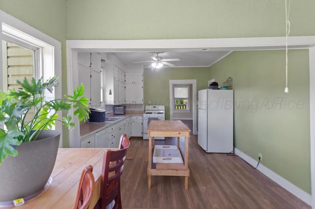 110 N Houston St, Shamrock, TX 79079 - kitchen with white appliances, dark wood-style floors, white cabinetry, and ceiling fan
