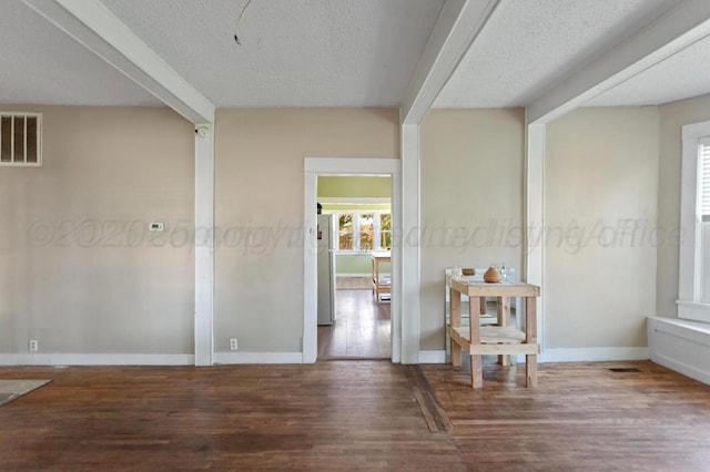 110 N Houston St, Shamrock, TX 79079 - empty room with wood finished floors and a textured ceiling