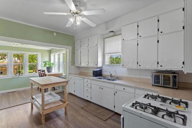110 N Houston St, Shamrock, TX 79079 - kitchen featuring white appliances, white cabinets, healthy amount of natural light, and dark wood-type flooring