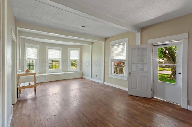 110 N Houston St, Shamrock, TX 79079 - entryway featuring a textured ceiling, hardwood / wood-style flooring, and beam ceiling