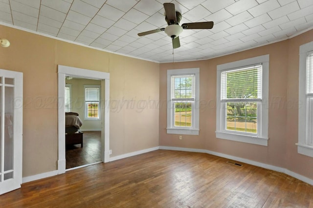 110 N Houston St, Shamrock, TX 79079 - empty room with hardwood / wood-style floors, ceiling fan, and ornamental molding