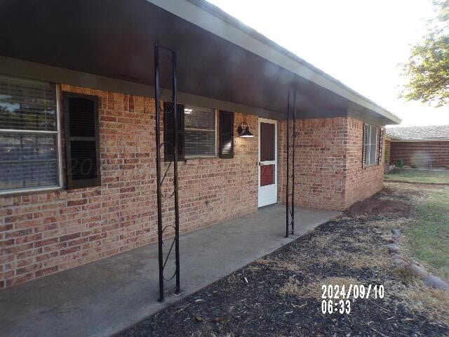 view of side of home featuring a patio area