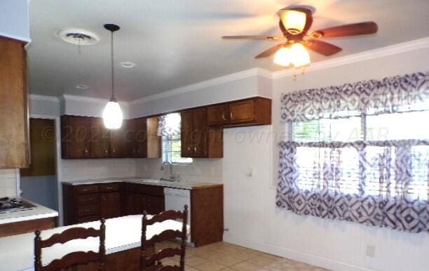 kitchen featuring tasteful backsplash, decorative light fixtures, ceiling fan, and crown molding