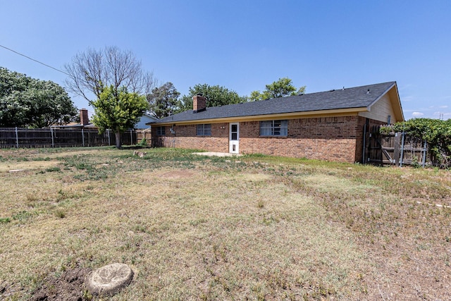 304 Romero St, Fritch, TX 79036 - back of house featuring brick siding and a chimney