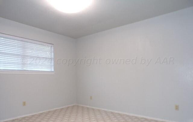 empty room featuring light carpet