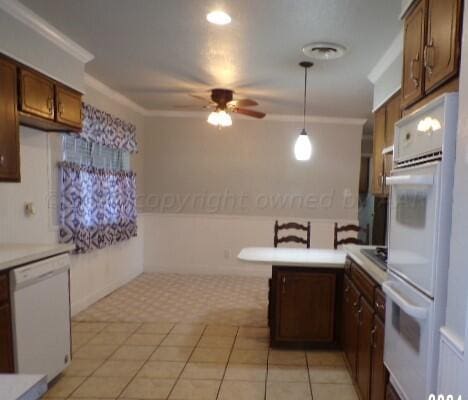 kitchen with white appliances, light tile patterned floors, and ornamental molding