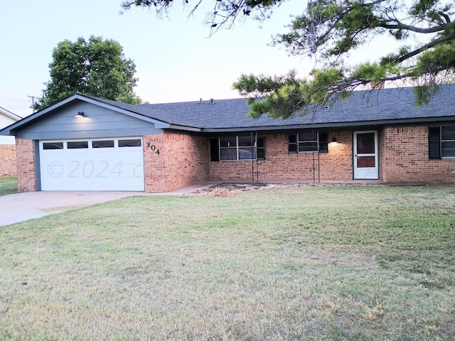 ranch-style home with a front lawn and a garage