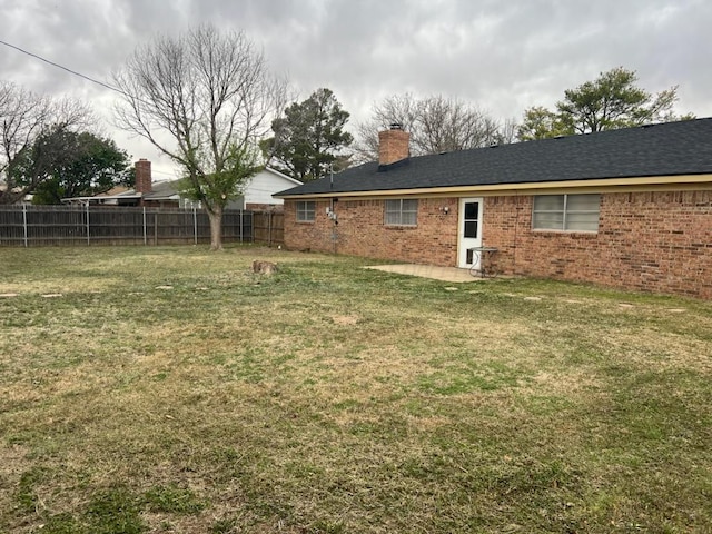 rear view of house featuring a yard