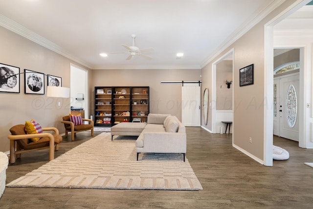 7809 Tarter Ave, Amarillo, TX 79121 - living room featuring a barn door, ceiling fan, crown molding, dark wood-type flooring, and recessed lighting