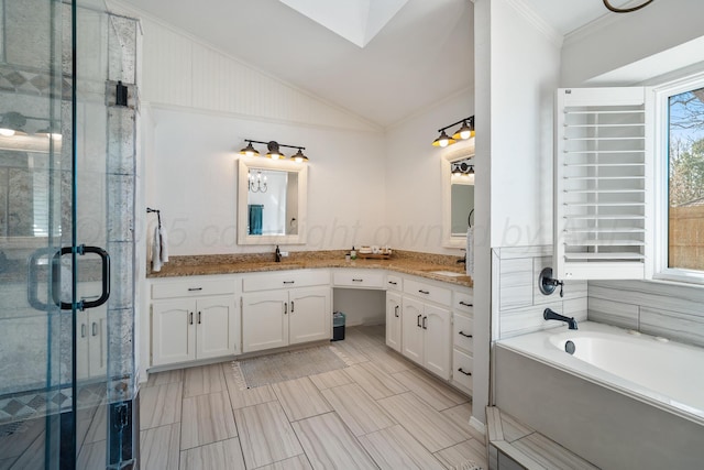 7809 Tarter Ave, Amarillo, TX 79121 - bathroom with double vanity, vaulted ceiling, crown molding, a shower stall, and a bath