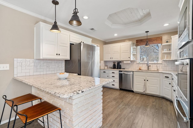 7809 Tarter Ave, Amarillo, TX 79121 - kitchen with appliances with stainless steel finishes, open shelves, a peninsula, light wood-type flooring, and white cabinetry
