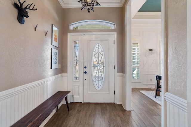 7809 Tarter Ave, Amarillo, TX 79121 - foyer with a chandelier, a textured wall, wood finished floors, a wainscoted wall, and crown molding