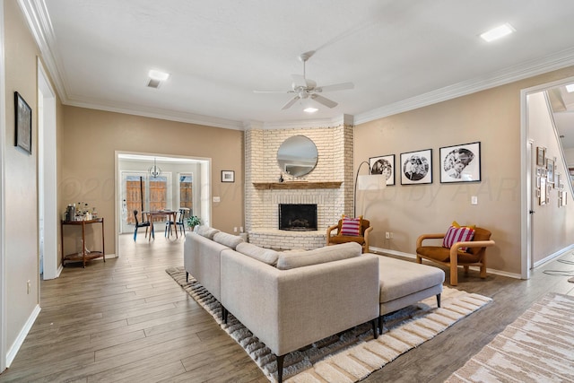 7809 Tarter Ave, Amarillo, TX 79121 - living room featuring a ceiling fan, crown molding, wood finished floors, and a brick fireplace