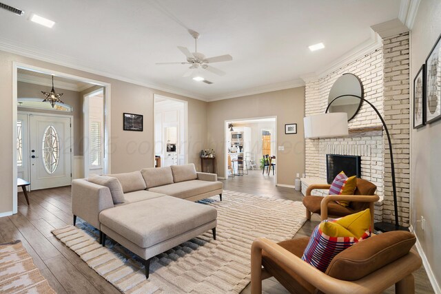 7809 Tarter Ave, Amarillo, TX 79121 - living room featuring hardwood / wood-style floors, ceiling fan, crown molding, and a brick fireplace