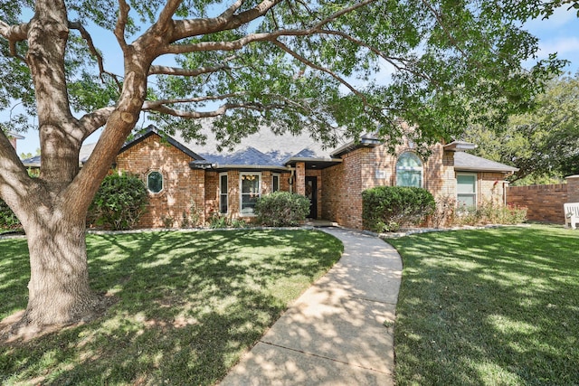 single story home featuring a front lawn