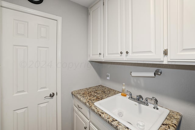 clothes washing area featuring sink