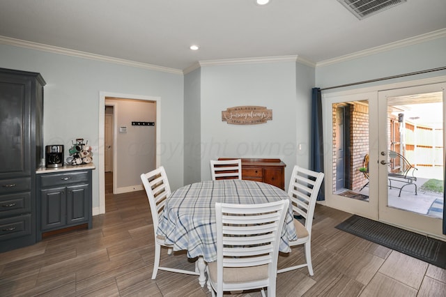 dining space with french doors and ornamental molding