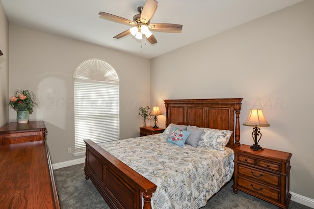 bedroom with ceiling fan and dark colored carpet