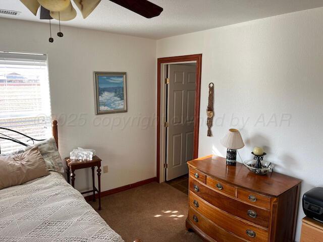 carpeted bedroom with ceiling fan