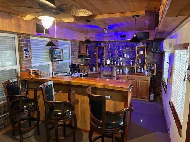 bar featuring wood ceiling, butcher block countertops, and hanging light fixtures