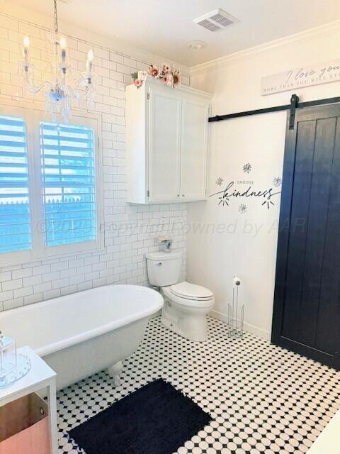 6508 Bayberry Ln, Amarillo, TX 79124 - bathroom featuring a soaking tub, crown molding, vanity, toilet, and tile walls