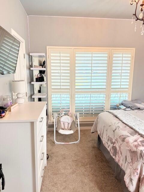 6508 Bayberry Ln, Amarillo, TX 79124 - bedroom featuring light colored carpet and a chandelier