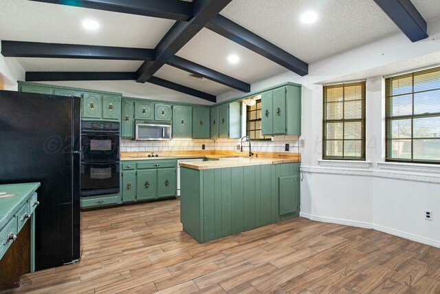6206 Yale St, Amarillo, TX 79109 - kitchen featuring green cabinetry, black appliances, a peninsula, light wood finished floors, and recessed lighting