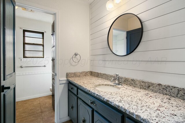 6206 Yale St, Amarillo, TX 79109 - full bathroom with vanity, tile patterned flooring, and wooden walls