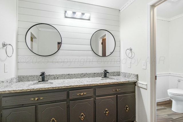 6206 Yale St, Amarillo, TX 79109 - full bathroom featuring double vanity, wood finished floors, ornamental molding, and wooden walls