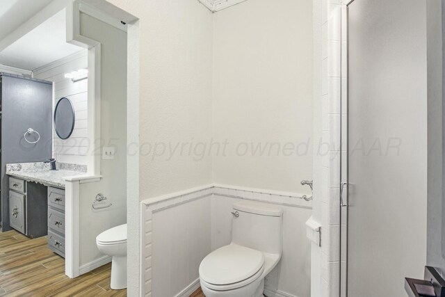 6206 Yale St, Amarillo, TX 79109 - full bath with vanity, wood finished floors, a shower stall, and wainscoting