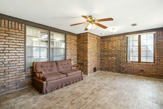 6206 Yale St, Amarillo, TX 79109 - living area with brick wall, brick patterned floors, and a ceiling fan