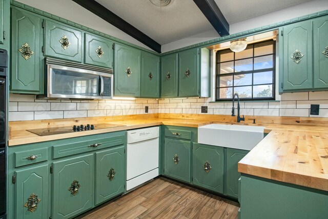 6206 Yale St, Amarillo, TX 79109 - kitchen with white dishwasher, stainless steel microwave, tasteful backsplash, beamed ceiling, and black electric cooktop