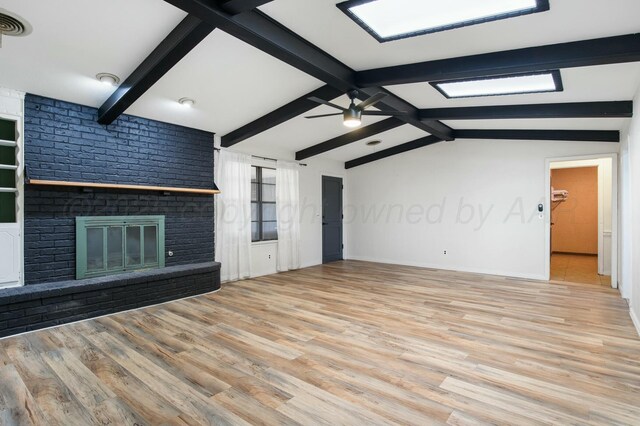 6206 Yale St, Amarillo, TX 79109 - unfurnished living room with wood finished floors, a ceiling fan, and a brick fireplace