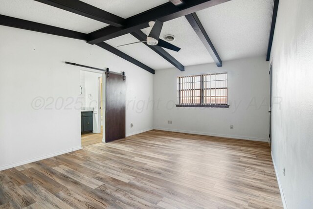 6206 Yale St, Amarillo, TX 79109 - empty room featuring a barn door, a ceiling fan, and light wood-style floors