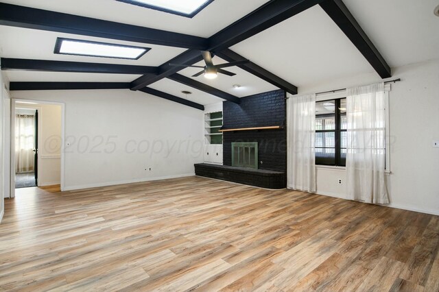 6206 Yale St, Amarillo, TX 79109 - unfurnished living room with wood finished floors, a fireplace, and ceiling fan