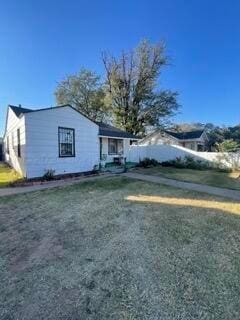 view of side of home with a lawn