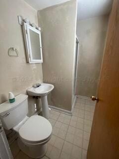 108 S Georgia St, Amarillo, TX 79106 - full bathroom with toilet, a shower stall, and baseboards