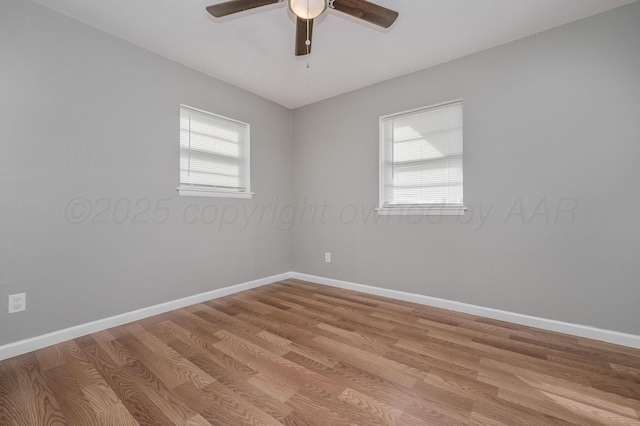 empty room with baseboards, light wood-type flooring, and a healthy amount of sunlight