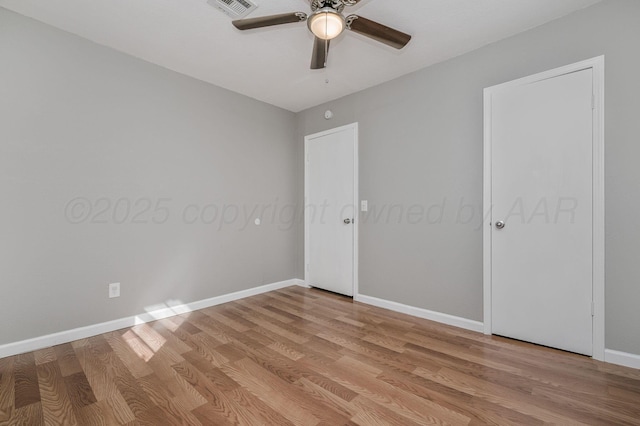 unfurnished bedroom with visible vents, ceiling fan, light wood-style flooring, and baseboards