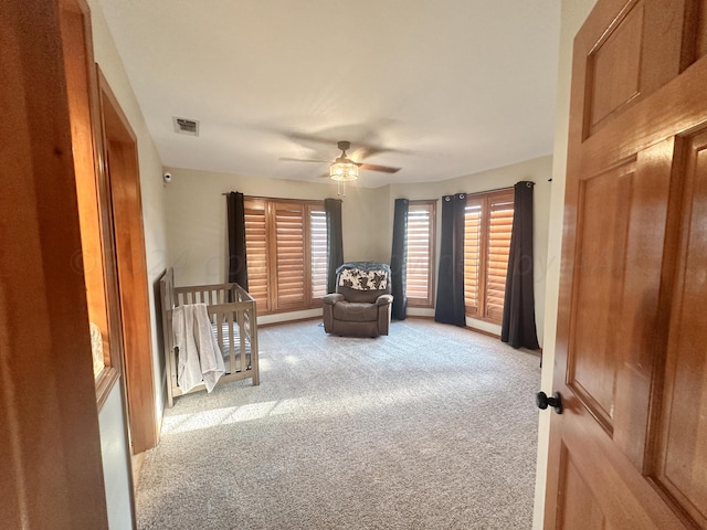 unfurnished bedroom with ceiling fan and light colored carpet