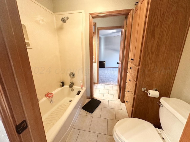 bathroom with tub / shower combination, tile patterned flooring, and toilet