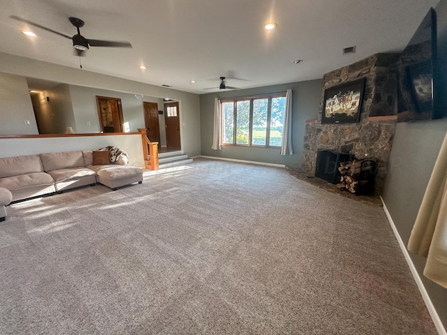 unfurnished living room with carpet flooring, ceiling fan, and a fireplace