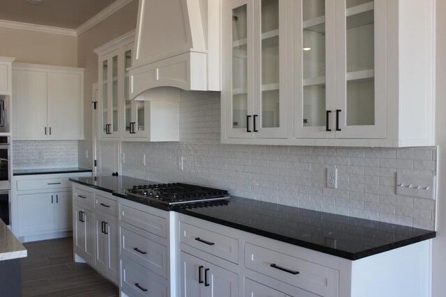 8104 Miami Ave, Amarillo, TX 79118 - kitchen featuring stainless steel appliances, ornamental molding, premium range hood, white cabinetry, and decorative backsplash