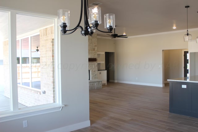8104 Miami Ave, Amarillo, TX 79118 - kitchen with ceiling fan, a chandelier, baseboards, ornamental molding, and decorative light fixtures